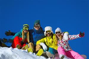 Four smiling snowboarders